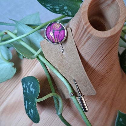 Purple and pink design on a stick pin brooch