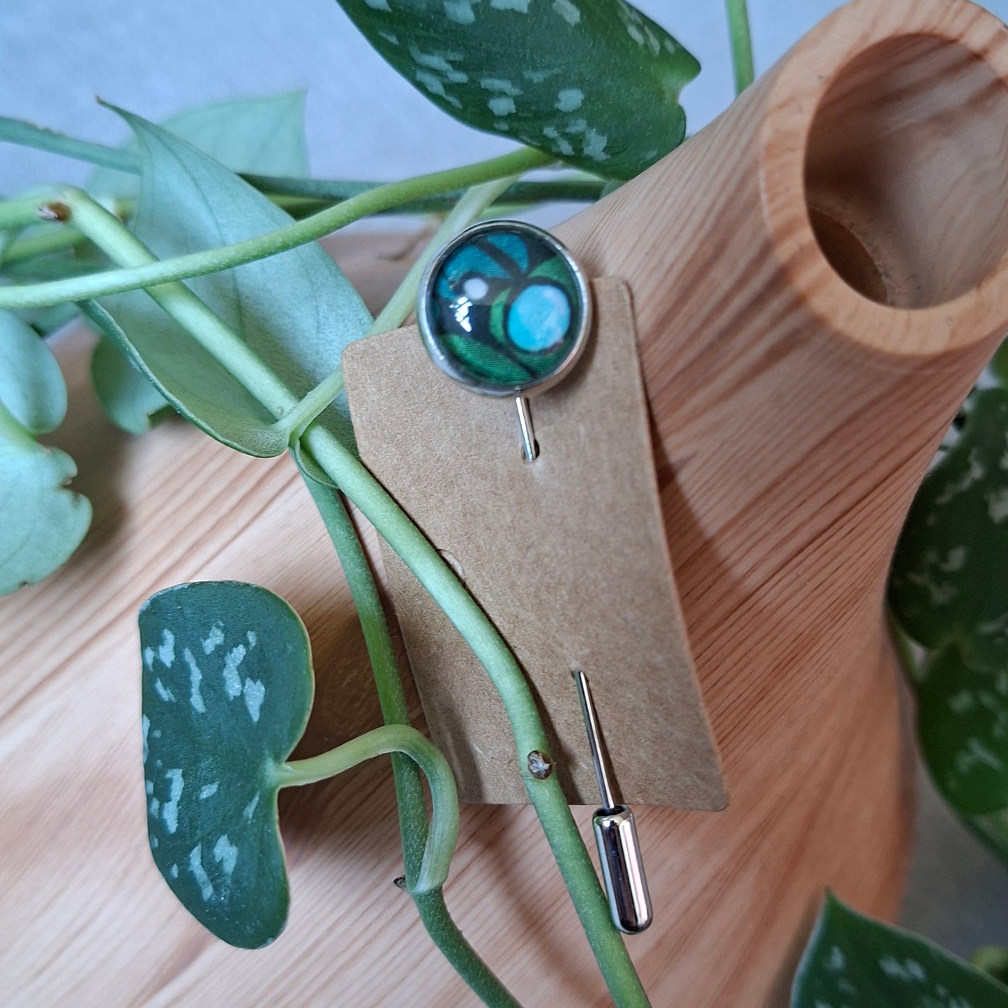 Blue and green bubble design on a stick pin brooch