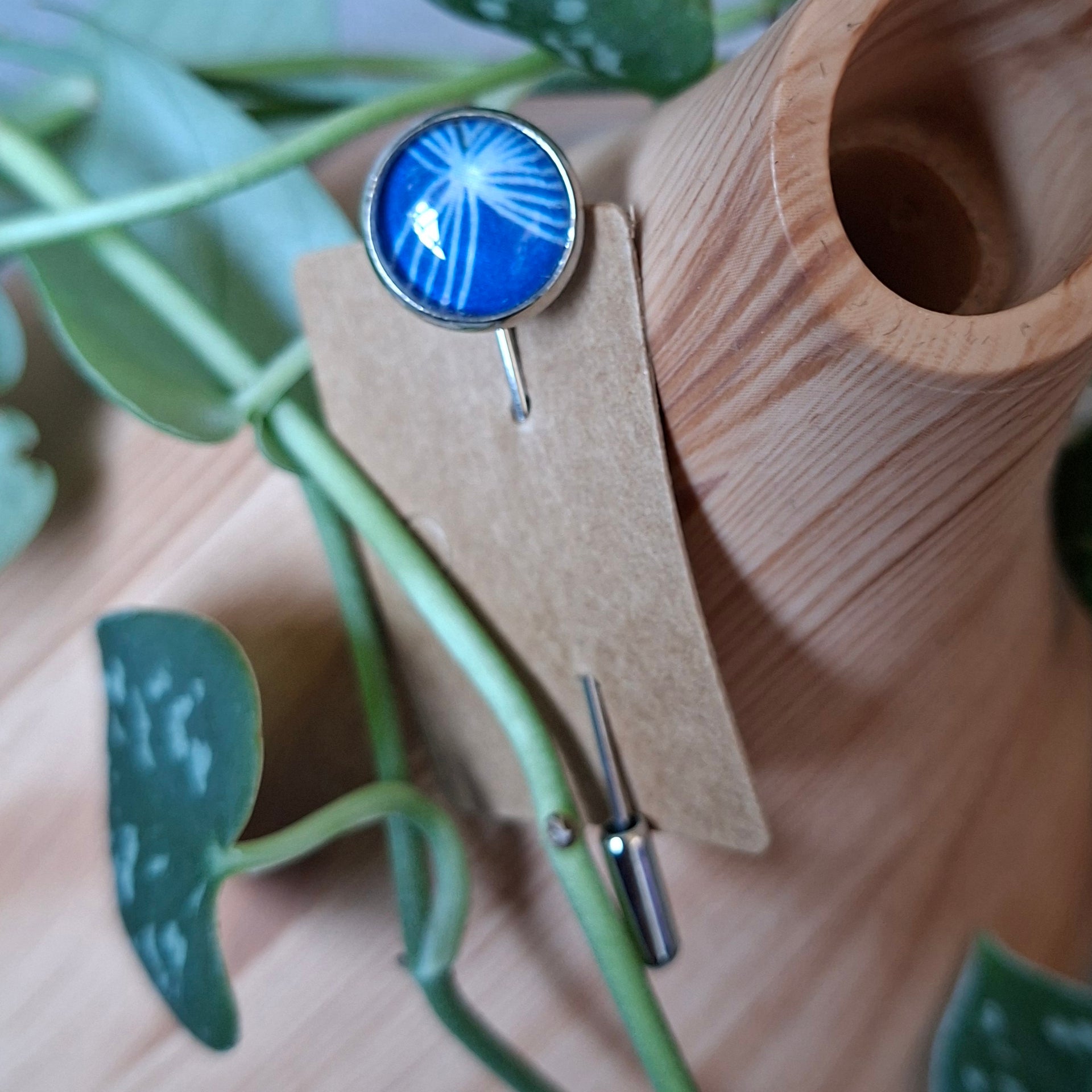 Blue and white design on a stick pin brooch